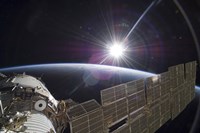 The International Space Station Backdropped by the Bright Sun over Earth's Horizon Fine Art Print