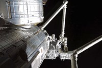 The Robotic Arm of the Japanese Experiment Module assists in installing components on the Japanese Exposed Facility Fine Art Print