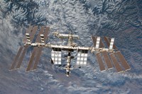 The International Space Station Backdropped by a Rugged Earth Terrain Fine Art Print