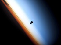 Silhouette of Space Shuttle Endeavour over Earth's Colorful Horizon Fine Art Print