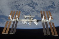 The International Space Station, Backdropped by the blackness of space and Earth's horizon Fine Art Print