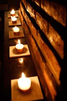 Lighted Candles and Brick Wall Fine Art Print