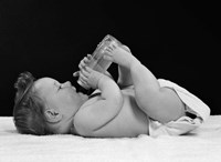 1950s Baby Lying On Back Drinking From Bottle Fine Art Print