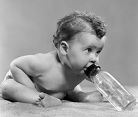1950s Baby Leaning Forward Drinking From Bottle Fine Art Print