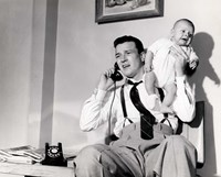 1950s Father Holding Baby While On The Phone Fine Art Print