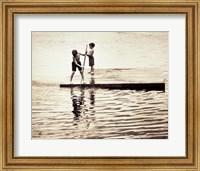 Two boys standing on a wooden platform in a lake Fine Art Print