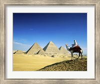 Man riding a camel near the pyramids, Giza, Egypt Fine Art Print
