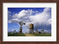 Low angle view of a water tower and an industrial windmill, 1880 Town, South Dakota, USA Fine Art Print