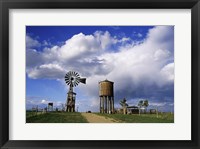 Low angle view of a water tower and an industrial windmill, 1880 Town, South Dakota, USA Fine Art Print