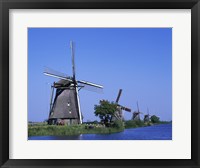 Windmills along a river, Kinderdike, Amsterdam, Netherlands Fine Art Print