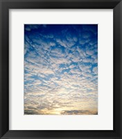 Low angle view of sunrise seen through clouds Fine Art Print