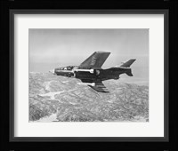 Side profile of a fighter plane carrying sidewinder missiles during flight, F9F-8 Cougar, US Navy Fine Art Print