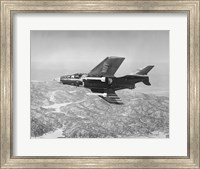 Side profile of a fighter plane carrying sidewinder missiles during flight, F9F-8 Cougar, US Navy Fine Art Print