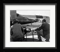 Rear view of two men crouching near fighter planes, X-15 Rocket Research Airplane, B-52 Mothership Fine Art Print