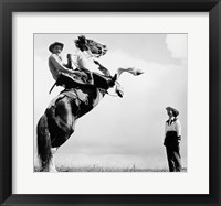 Low angle view of a cowboy riding a bucking horse Fine Art Print