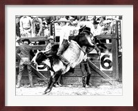 Side profile of a cowboy riding a bull at a rodeo Fine Art Print