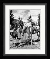 Teenage cowboys sitting on rail fence Fine Art Print
