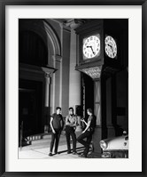 Young men standing below clock at night Fine Art Print