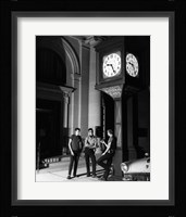 Young men standing below clock at night Fine Art Print