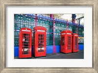 Four telephone booths near a grille, London, England Fine Art Print