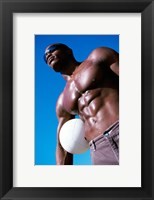 Low angle view of a young man holding a volleyball Fine Art Print