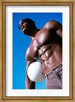 Low angle view of a young man holding a volleyball Fine Art Print