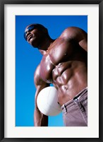 Low angle view of a young man holding a volleyball Fine Art Print