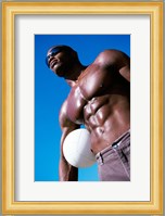 Low angle view of a young man holding a volleyball Fine Art Print