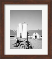USA, Farmer Working on Tractor, Agricultural Buildings in the Background Fine Art Print