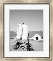 USA, Farmer Working on Tractor, Agricultural Buildings in the Background Fine Art Print