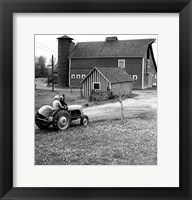 Man with a Boy Riding a Tractor in a Field Fine Art Print