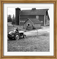 Man with a Boy Riding a Tractor in a Field Fine Art Print