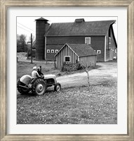 Man with a Boy Riding a Tractor in a Field Fine Art Print
