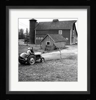 Man with a Boy Riding a Tractor in a Field Fine Art Print