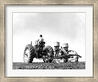 Low Angle View of a Farmer Planting Corn with a Tractor in a Field Fine Art Print