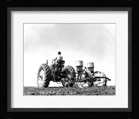Low Angle View of a Farmer Planting Corn with a Tractor in a Field Fine Art Print