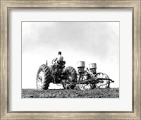 Low Angle View of a Farmer Planting Corn with a Tractor in a Field Fine Art Print