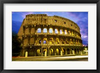 Low angle view of the old ruins of an amphitheater lit up at dusk, Colosseum, Rome, Italy Fine Art Print