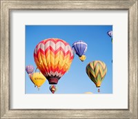 Low angle view of hot air balloons in the sky Fine Art Print