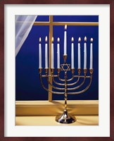 Close-up of burning candles on a menorah at a window Fine Art Print