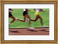 Low section view of male athletes running on a running track Fine Art Print