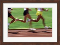 Low section view of male athletes running on a running track Fine Art Print