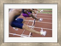 Side profile of three people jumping a hurdle Fine Art Print