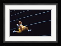 High angle view of a young man running on a running track Fine Art Print