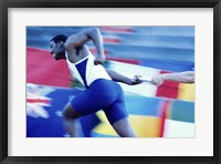 Side profile of runners passing a baton in a relay race Fine Art Print