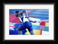 Side profile of runners passing a baton in a relay race Fine Art Print