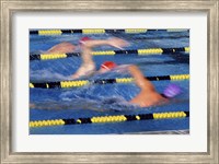 Rear view of three swimmers racing in a swimming pool Fine Art Print