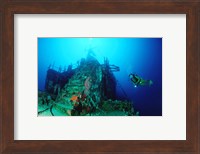 Scuba diver watching a shipwreck underwater Fine Art Print