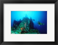 Scuba diver watching a shipwreck underwater Fine Art Print