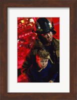Close-up of a firefighter carrying a boy Fine Art Print